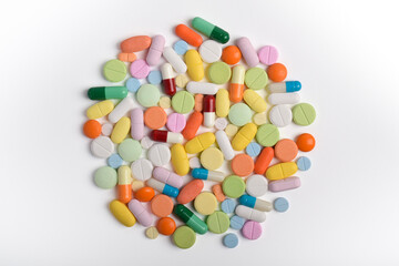 Various colorful pills and capsules on white background, displaying various medicines, vitamins and supplements for healthcare and pharmacy concept.