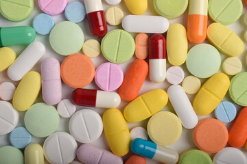 Close-up of colorful pills, tablets, and capsules, showing various medications and supplements for healthcare, pharmacy, and medical treatment concepts.