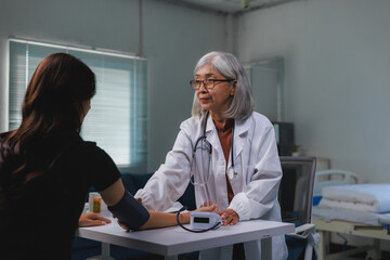 Senior doctor measuring blood pressure during patient check up