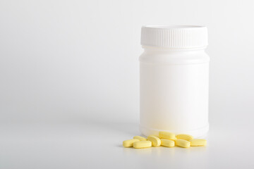 Plastic jar with pills isolated on white background.