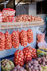 Tashkent, Uzbekistan. October 30, 2025. Newly harvested onions, carrots, and potatoes are displayed in sacks at a local market.