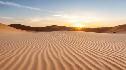Golden sand dune sunrise with rippled foreground and distant silhouette hills