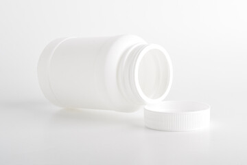 Opened blank plastic bottle medicine isolated on white background.