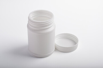 Opened blank plastic bottle medicine isolated on white background.