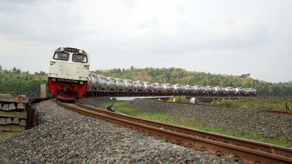 A fast-moving train glides smoothly along the railway tracks, showcasing power, motion, and precision in transportation © AntxPhotoStock