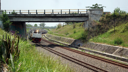 A fast-moving train glides smoothly along the railway tracks, showcasing power, motion, and precision in transportation © AntxPhotoStock