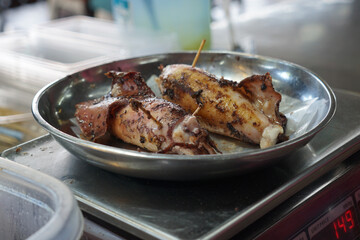 Grilled Squid on Market Scale Display