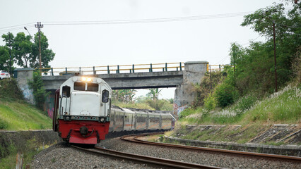 A fast-moving train glides smoothly along the railway tracks, showcasing power, motion, and precision in transportation © AntxPhotoStock