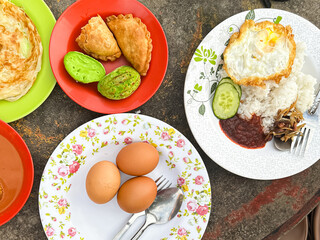 Traditional Malaysian Breakfast Assortment on Colorful Plates