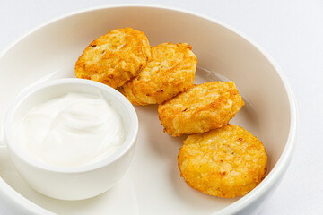 Golden brown potato rounds perfectly crispy on the outside, served with a smooth, tangy dip