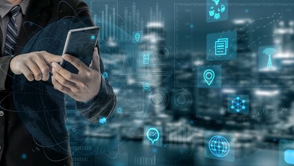 A businessman engages with a smartphone, surrounded by digital interface elements depicting data visualization and technology concepts in an urban setting. Xenic