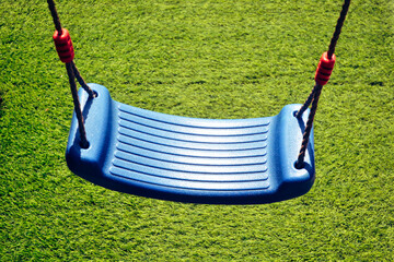 Empty swing hanging in the green park