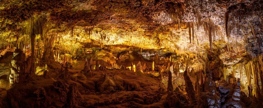 Explore the stunning caves of Mallorca, Spain. Witness the breathtaking stalactites and stalagmites in this underground paradise, perfect for tourists seeking adventure.