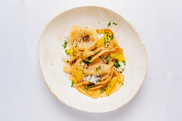 Fresh pasta with vibrant yellow sauce and herbs makes a delightful dish