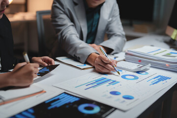 Business professionals analyzing financial data reports late