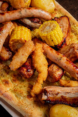 A delicious assortment of grilled sausage, shrimp, corn, and potatoes creates a hearty meal