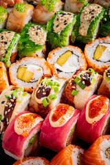 Fresh sushi rolls with unique toppings artfully arranged on a platter invite you to taste