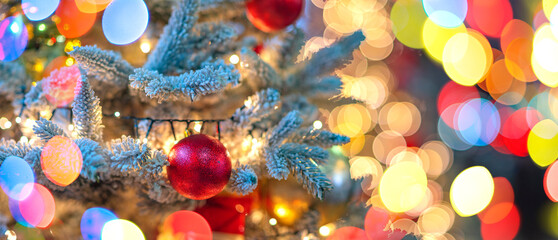A Christmas tree with garlands on a city street.