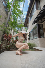 Woman in sexy bikini with tropical garden background.