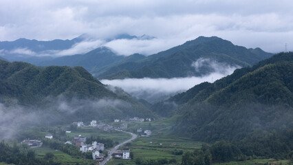 Mountains and villages under the clouds and mist in the early morning of southern Anhui