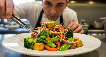 Chef Plating Vegetable Dish Asian Cuisine with Tofu, Broccoli, Carrot, Pepper, Onion, Sesame Seeds Culinary Art Food Styling