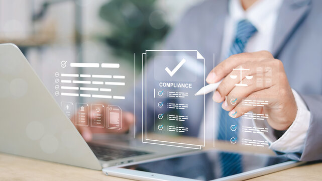 Business person stamping documents with a digital compliance interface showing checklists, legal icons, and approval status. Concept of regulatory compliance and document verification.