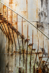 old rusted stairs on a storage tank