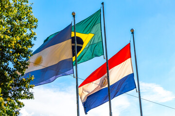 Brazilian Argentine and Paraguayan flag flags blue sky in Brazil.