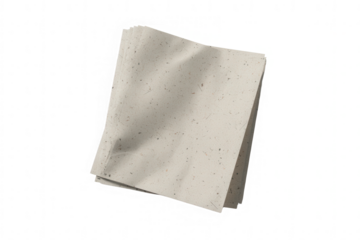 A single folded light beige paper napkin against a black background