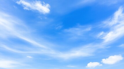 Obraz premium Bright blue daytime sky with scattered wispy cirrus clouds and soft distant clouds