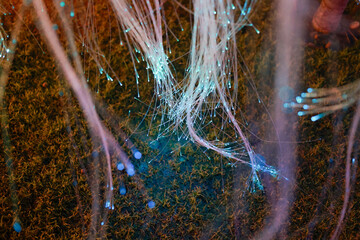 Abstract glowing fiber optic background shows magical network of colorful light strands, creating sense of ethereal connection and futuristic technology with touch of wonder