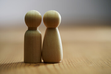 wood  couple figurines on wood table.