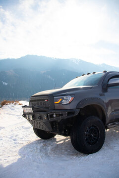 Enilchek, Kyrgyzstan - December 13, 2024: Detail shot of modified front bumper and winch on grey pickup truck in snowy mountains