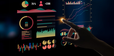 A close-up image of a hand interacting with vivid data visualizations on a touchscreen, representing modern analytics and technology in business environments. Impute