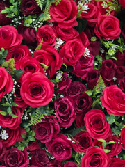 Fototapeta premium Beautiful background of red rose flowers, romantic bouquet symbolizing love and passion. vibrant floral decoration for special celebration or affectionate gift