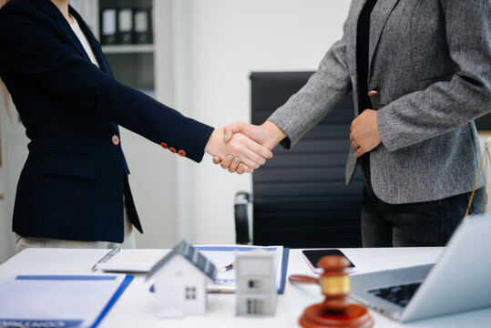 Professional business handshake after real estate contract agreement, showing partnership, trust, and successful deal in office.