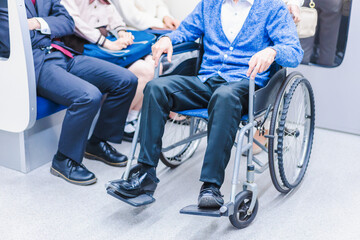 車イスで電車に乗る乗客
