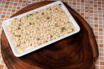 Fresh bean sprouts on cutting board at table, fresh vegetables, cooking at home. 