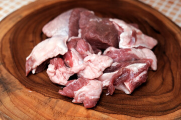 Raw chopped beef meat. Raw meat beef, on old wooden board at table background. Raw uncooked meat. Top view with copy space.