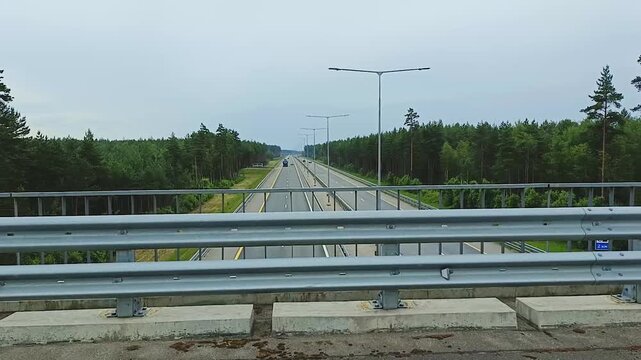 Russia. The M11 highway with cars moving along it. Aerial view from the overpass