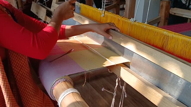 Handloom weaver in India working in her loom.
