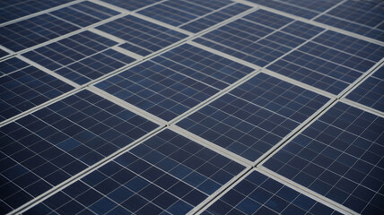 Close-up view of dark blue solar panels arranged in a grid pattern, capturing renewable energy for sustainable power generation.
