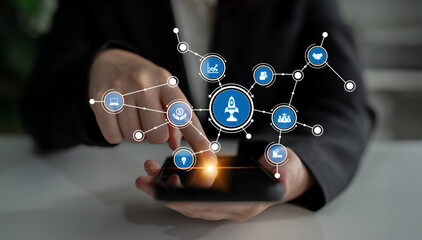 A business professional interacts with a smartphone as network connections and icons representing innovation and ideas emerge, symbolizing modern digital communication. Tessel