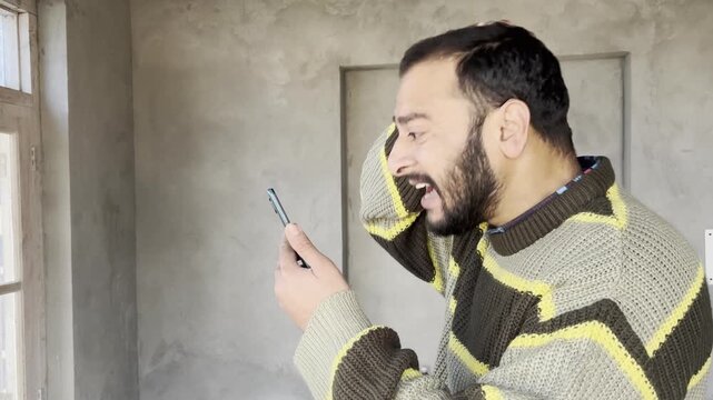 Man receive fraud message or scam message gets annoyed angry and frustrated. Man showing angry or annoyed after seeing fraud message from scammers using harsh words. Man gets scammed or cheated.