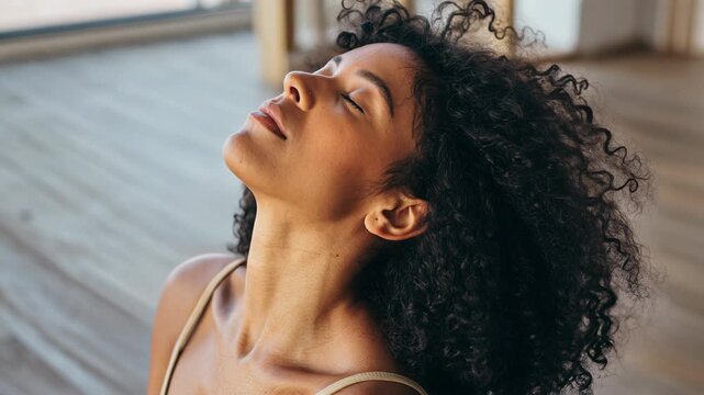Energizing yoga practice with a woman in a serene indoor space embracing mindfulness and relaxation