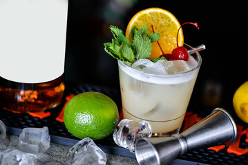 cocktail in a glass with white foam with a slice of orange on a gray background