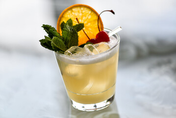 cocktail in a glass with white foam with a slice of orange on a glass background