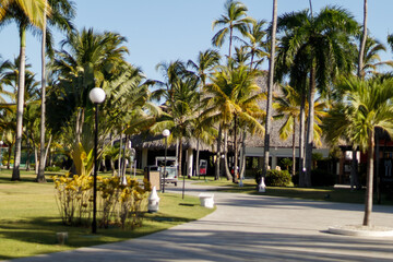 A beautiful seaside resort with palm trees, colorful buildings, and artistic statues on a sunny summer day. Vacation season in the Caribbean. Hotel in Punta Cana, Dominican Republic, July 22, 2025