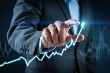 Businessman hand touching growing stock market graph on virtual screen symbolizing financial growth strategy