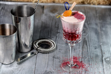 cocktail in a glass with red foam on a silver background
